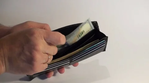 Men's hands count dollar bills in a wallet. Stock Footage 77822348