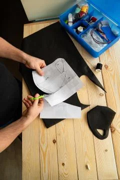 Mens hands cut out pattern mask with scissors. Stock Photos