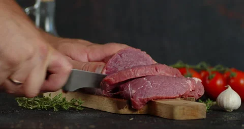 Men's hands cut raw beef into pieces. Stock Footage 139153090