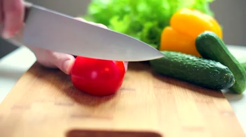 Men's hands cut tomato Stock Footage 57859161
