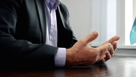 Men's hands during the interview, a man in a dark suit sitting at the table Stock Footage 106408801