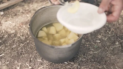 Men's hands with a fork put boiled potatoes from a pot Boiled potatoes in a Stock Footage 153708686