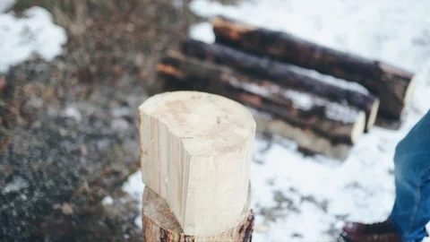 Men's hands in gray gloves and watches holding an axe and chopping wood in Stock Footage 128002653