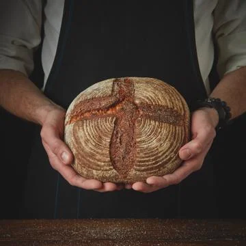 Men's hands hold bread Stock-Fotos