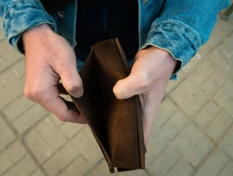 Men's hands hold an open empty wallet. No cash. Stock Photos