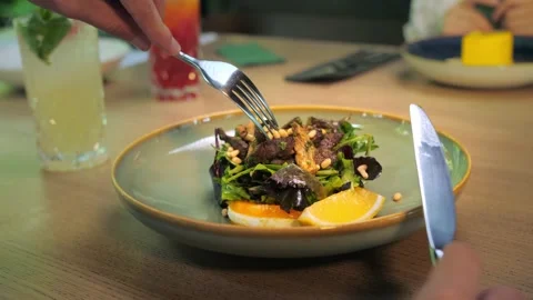 Men's hands holding a fork and eating a salad in a restaurant. Eating Calf S Stock Footage 202477854