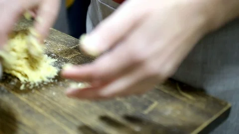 Men's hands knead a small ball of dough on a dark board Stock Footage 100980774