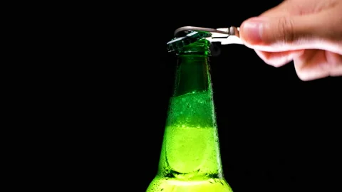Men's hands open bottle of beer. Refreshing and cold beer Stock Footage 154192124