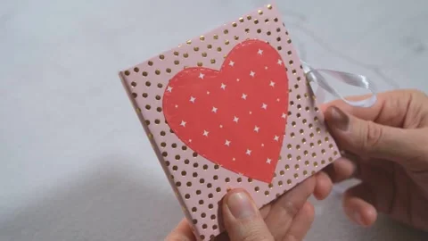 Men's hands open a card made by hands 스톡 동영상 169995999