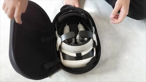 Mens hands open the case with VR glasses on a gray background. Teenagers and Stock Footage 313266394