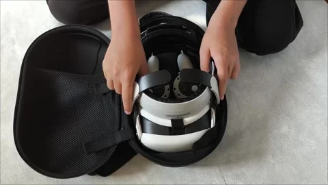 Mens hands open the case with VR glasses on a gray background. Teenagers and 動画素材 313266466