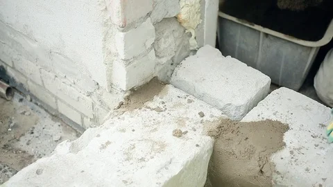 Men's hands put cement mortar on the silicate blocks Stock Footage 112802544