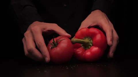 Men's hands put colored red pepper and tomato on the table and show thumbs up on Stock Footage 144370757