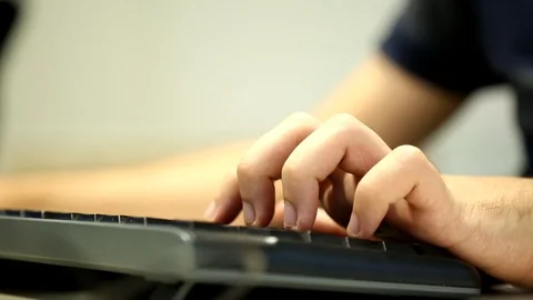 Men's Hands That Quickly Knock on a Black Keyboard 動画素材 99540066