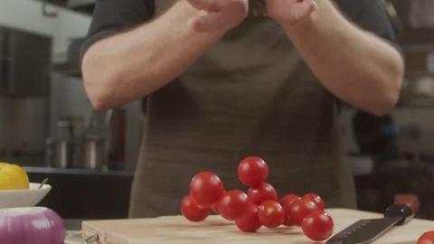 Men's hands release a handful of cherry tomatoes on the kitchen table. Cherry Stock Footage 123051589