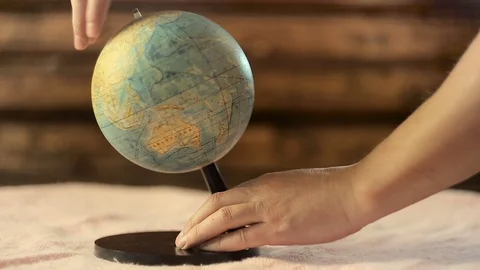 Men's hands rotate the globe quickly Stock Footage 89566832