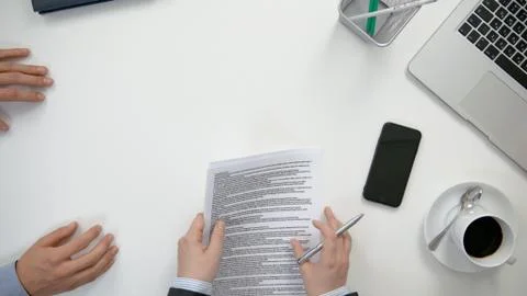 Men's Hands Signing a Document Stock Photos