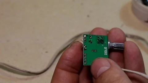 Men's hands solder the wire to the PCB with details Stock Footage 89545440