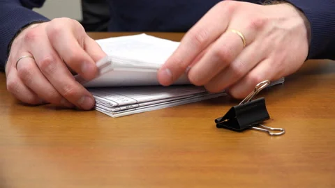 Men's hands sorting documents on the table Stock Footage 99933120