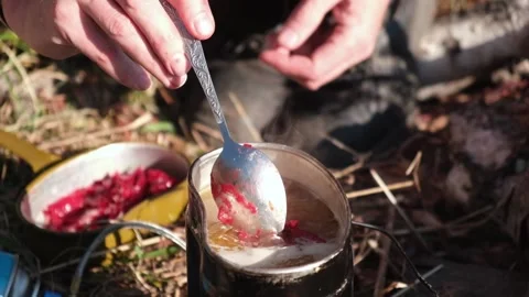 Men's hands spoon the borscht dressing into the boiling broth. Slow motion. Stock Footage 168091503