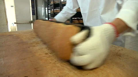 Men's hands spread baked bread from molds Stock-Footage 99614758