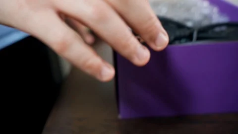Men's hands take the network cable out of the box and lay it on the table. The Stock Footage 121754163
