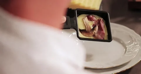 Men's hands take saucer from table squeegees pour it into their plate spatula Stock Footage 179026180