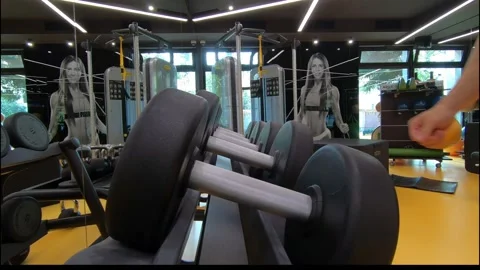 Men's hands take weights for exercise in the gym Video stock 137203371