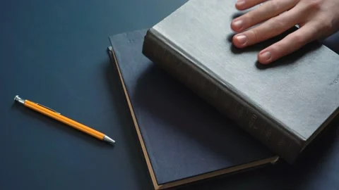 Men's Hands Taking a Book Stock Footage 148347098