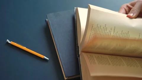 Men's Hands Taking &amp; Leafing Through a Book Stock Footage 148347173