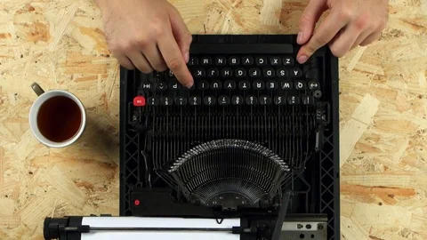Men's hands type the text of the book on a typewriter. View from above Stock Footage