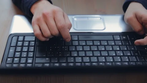 Men's hands type the text on the keyboard of the laptop 動画素材 94048077