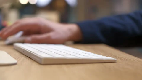 Men's hands type on a white keyboard, then scroll. Gadgets with modern design. Stock Footage 231894154