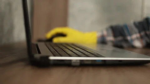 Men's hands type in yellow gloves on a laptop Video stock 129081483