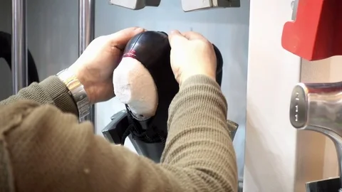 Men's hands use a machine for shaping shoe on the factory. Stock Footage 85061753