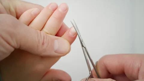 Men's hands use scissors to trim the nails on a child's hand. Important hygiene Video stock 263673689