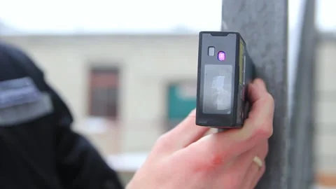 Men's hands using a laser rangefinder measure the length of an object Stock Footage 222103464