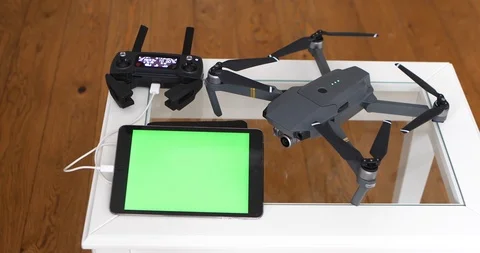 Men's Hands Using Tablet With Green Screen Connected To Copter Via Control Panel Stock Footage 104592502