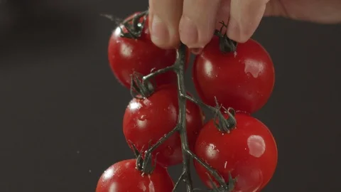 Men's hands wash twig with cherry tomatoes. Slow motion video Stock Footage 123960347