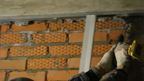 Men's hands in  working gloves, drill  hole in  steel profiles Video stock 99389069