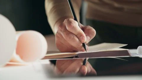 Men's hands write in the diary, take notes and write to the organizer. Stock Photos
