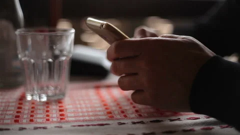 Men's hands write a message on a smartphone at the table A glass transparent  Stock Footage 150278275
