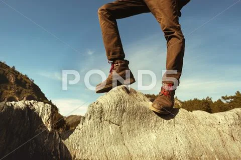 Men's legs closeup rock concept Stock Photos