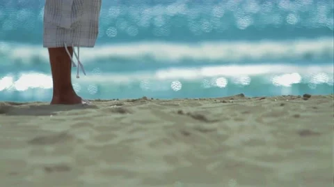 Men's legs walking down the beach in slow motion Stock Footage 54593445