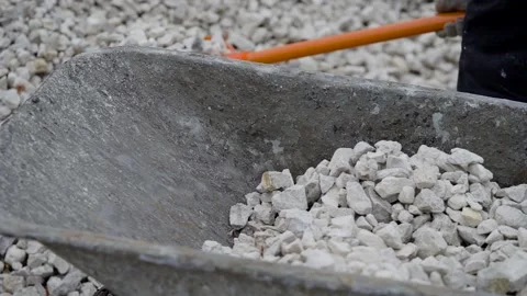 Men's work at a construction site. A man drives rubble on a wheelbarrow. Stock Footage 143538783