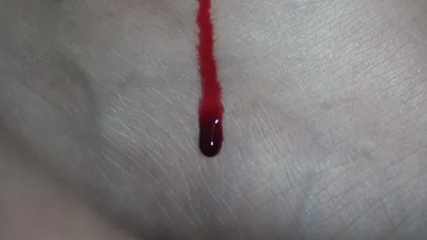 Menstrual blood flowing and tracking slowly down the inside of woman thigh. Stock Footage 329541753