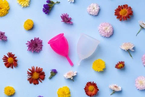 Menstrual cup on floral pattern background top view 스톡 사진