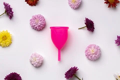 Menstrual cup on floral pattern background top view 스톡 사진