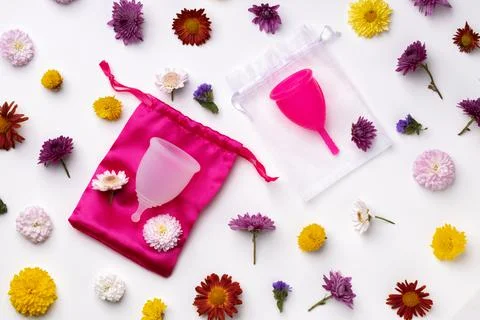 Menstrual cup on floral pattern background top view 스톡 사진