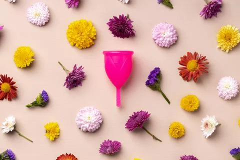 Menstrual cup on floral pattern background top view 스톡 사진